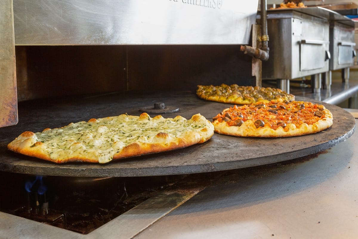 Manaeesh and savory pies baking in Taza's stone oven